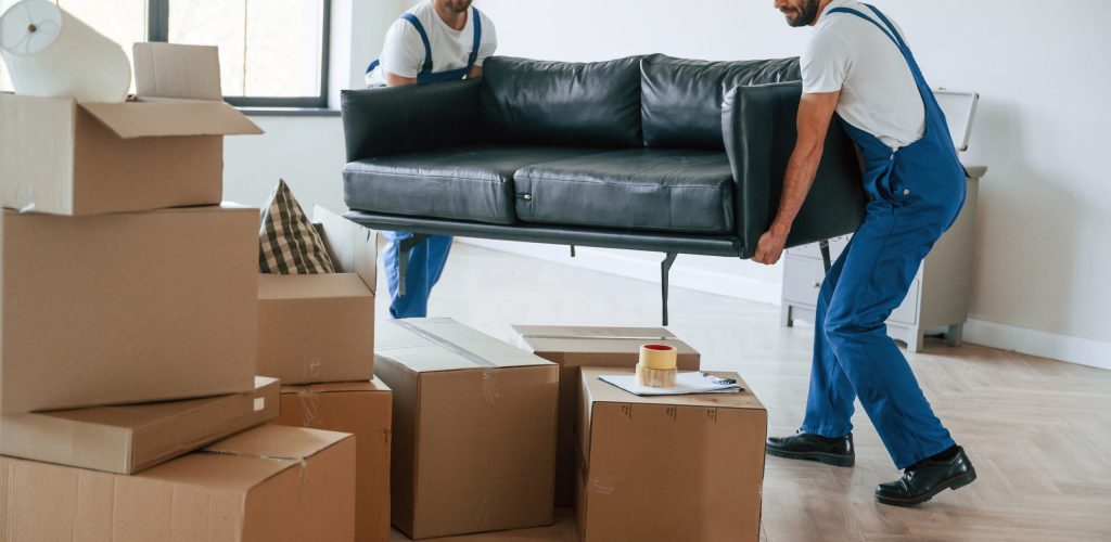 Two moving service employees in a room.